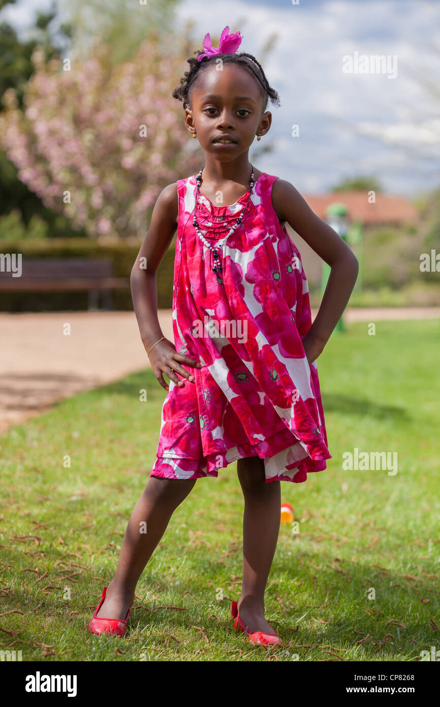 Outdoor portrait of a cute african american little girl, with the hands on the hips Stock Photo