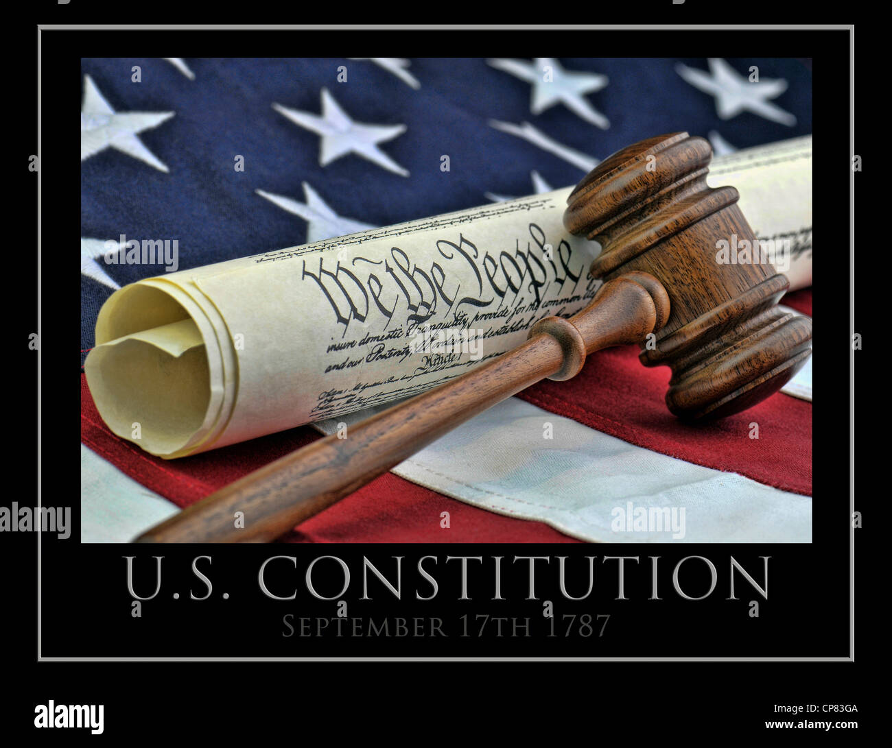 United States Constitution with wooden judge's gavel, and American flag background Stock Photo