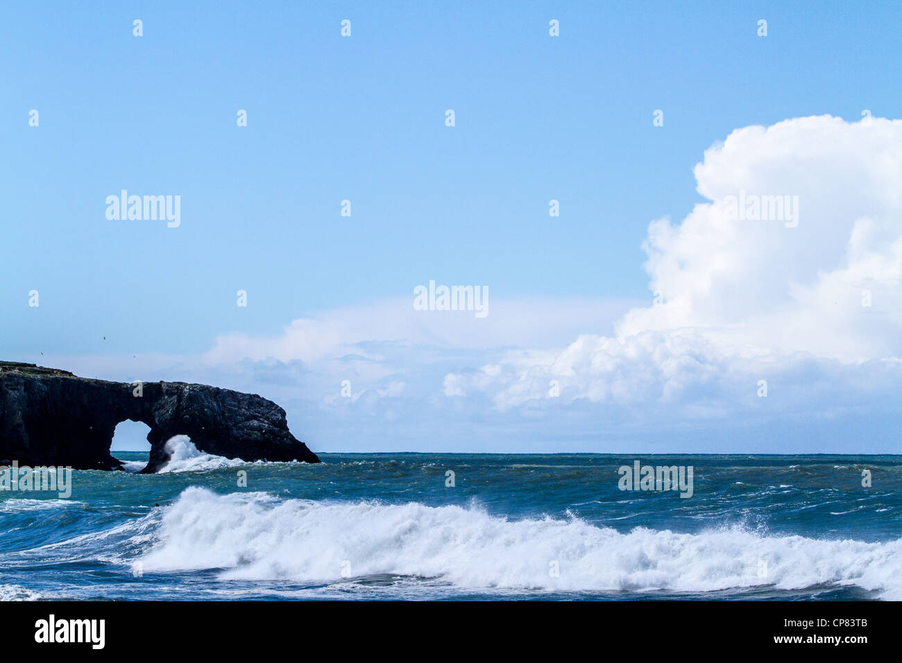 Arched rock and cloud bank at Goat Rock State Beach in Sonoma County California Stock Photo