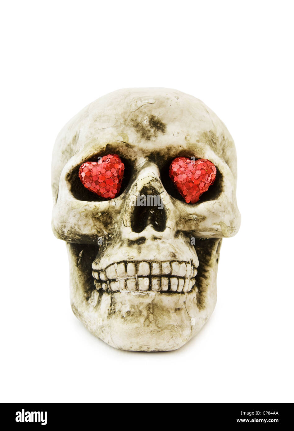 Halloween love with scary skull and sparkling red hearts. Isolated on white background. Stock Photo