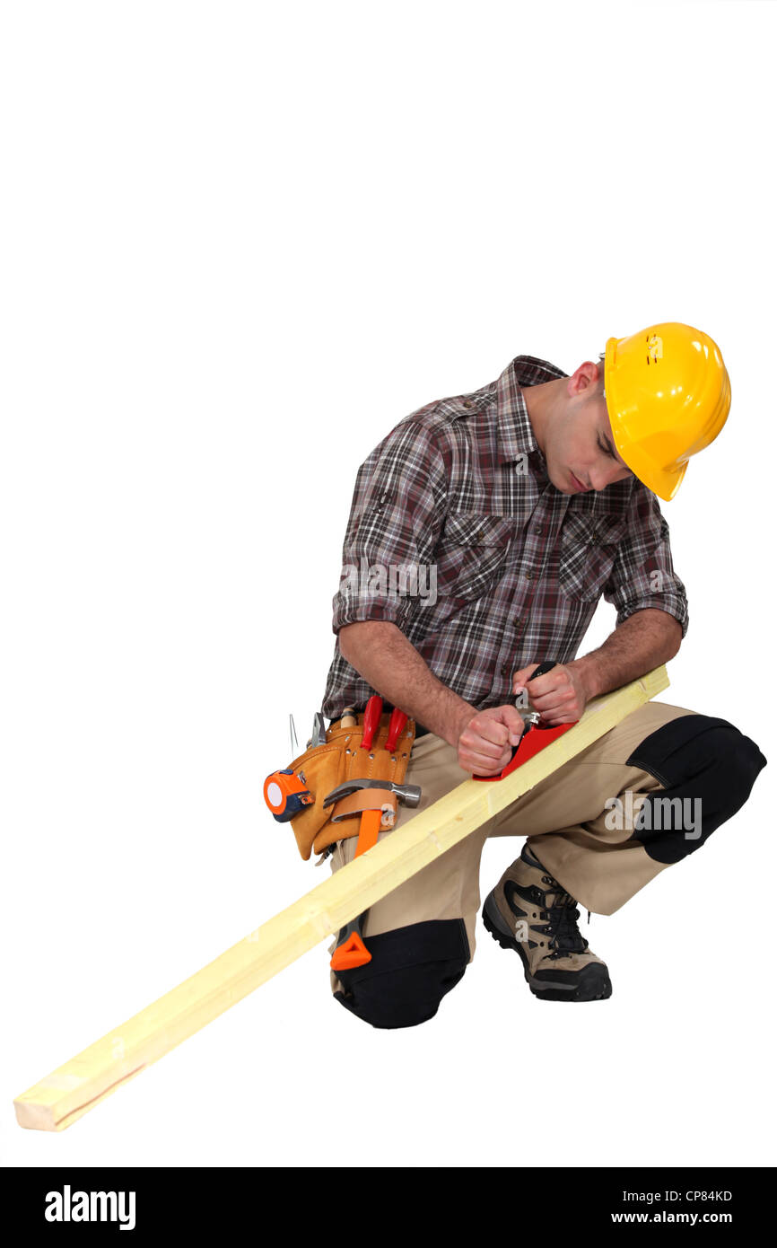 carpenter at work sharpening timber Stock Photo