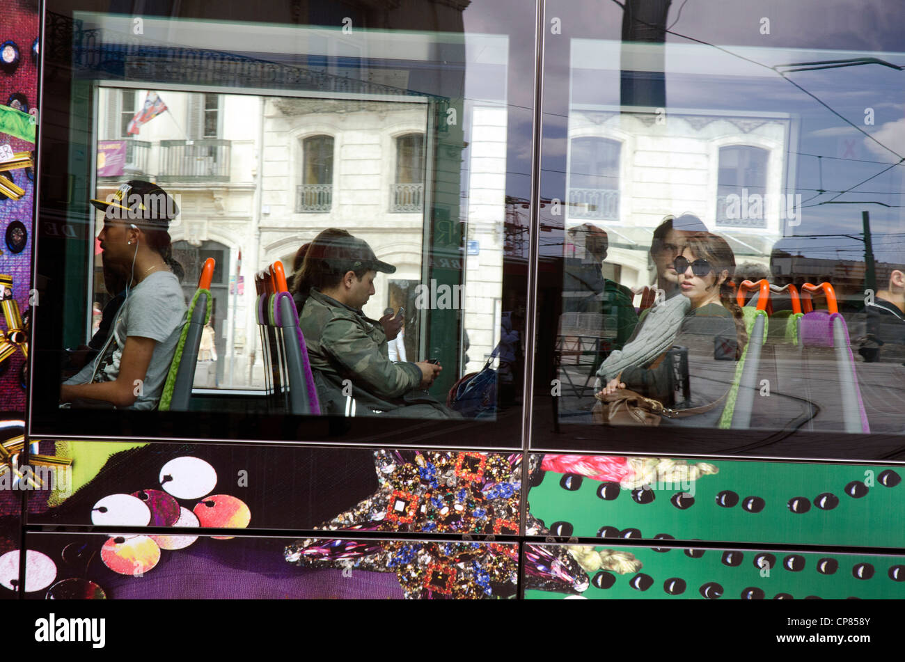 Passengers on a colorfully designed tram in Montpellier, south of France. They have four tram lines. Stock Photo