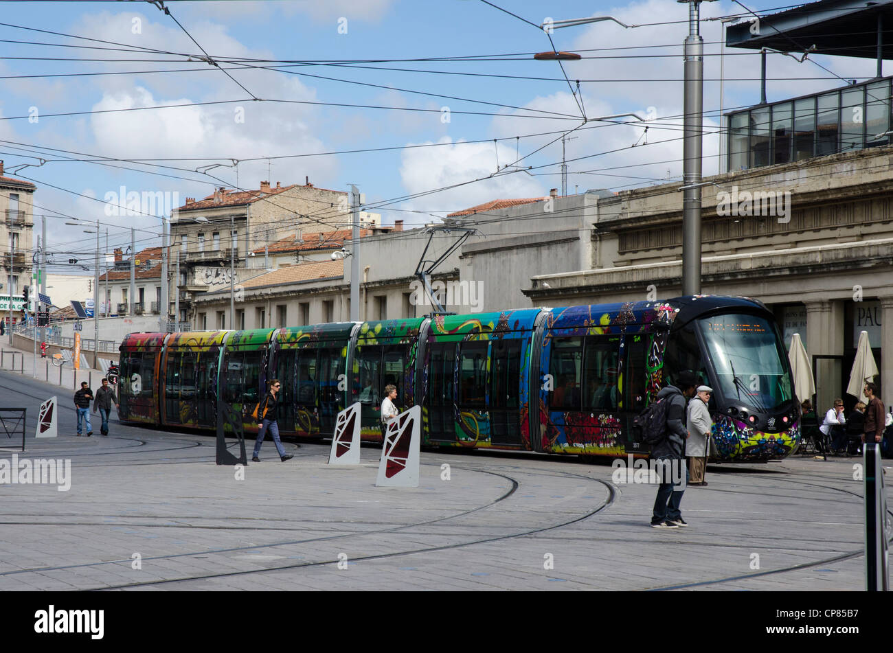 Colorful tram - streetcar - passing near the train station in Montpellier. Stock Photo