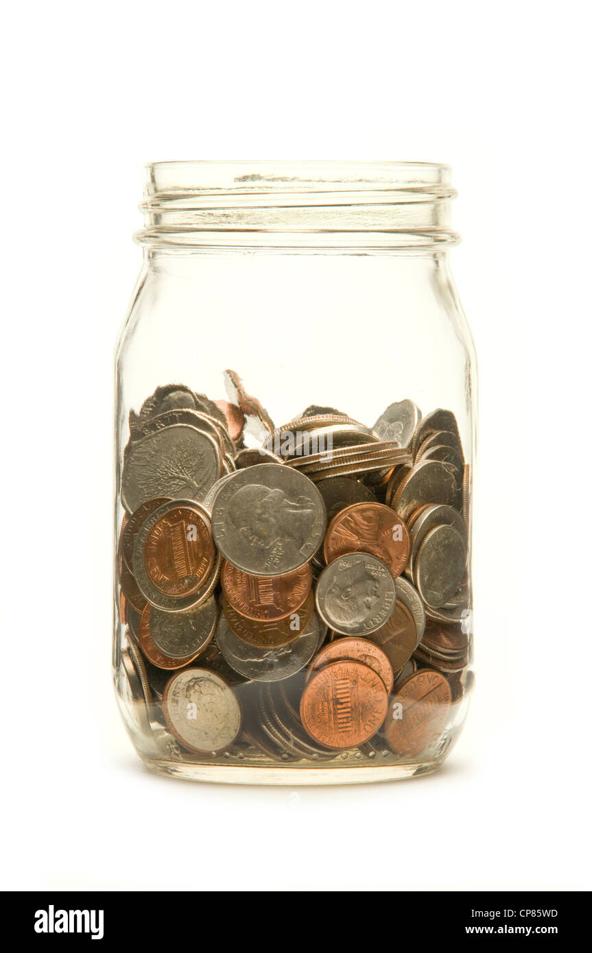 American coins in a glass jar against a white background Stock Photo