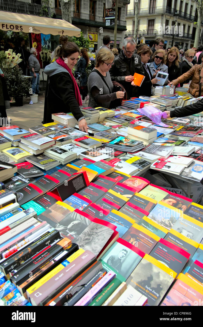 Book stall and customers on La Rambla in Barcelona on St. George Day, 2012. Stock Photo