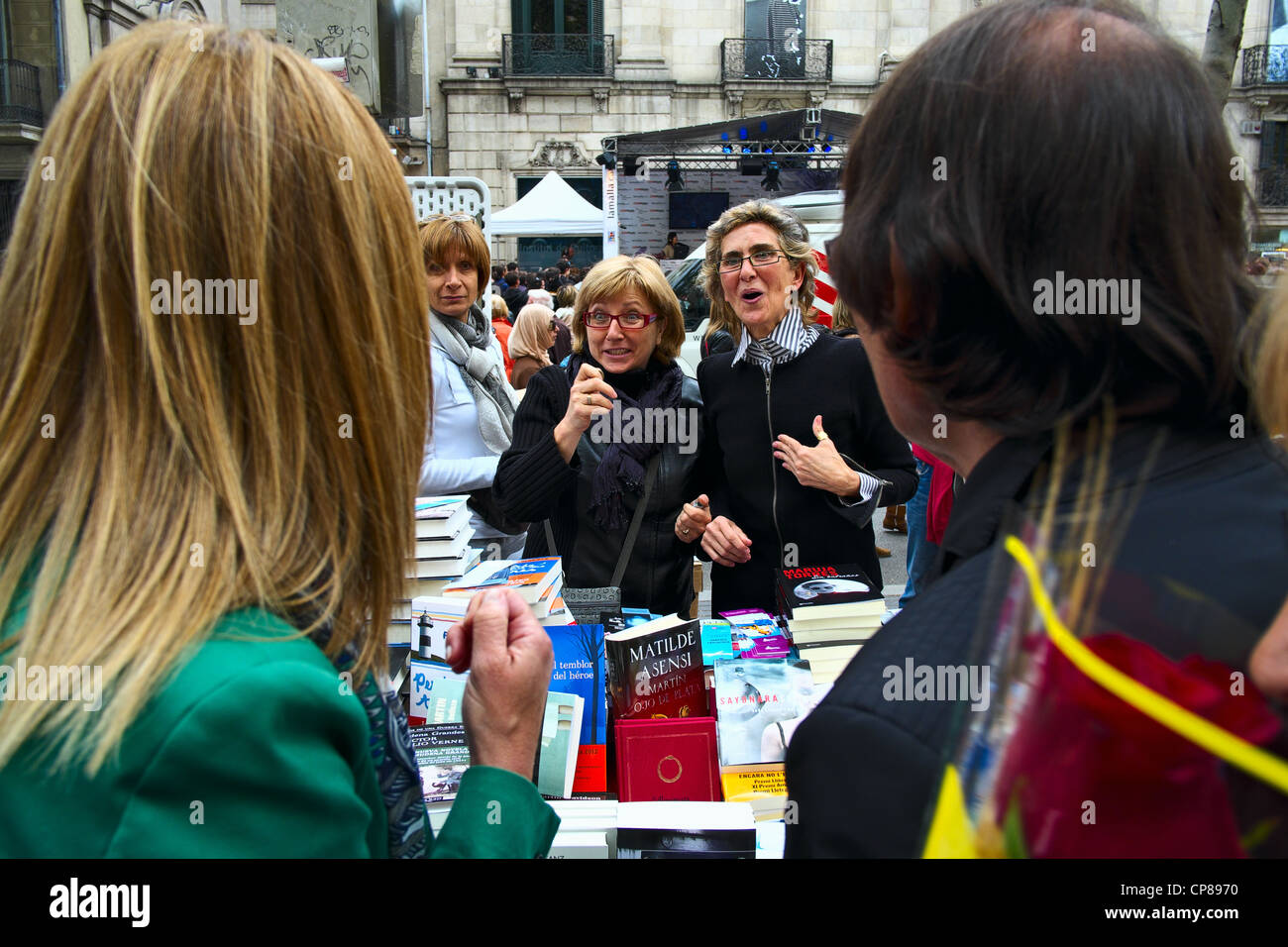 Book stall, vendors and shoppers on La Rambla in Barcelona on St. George Day, 2012. Stock Photo