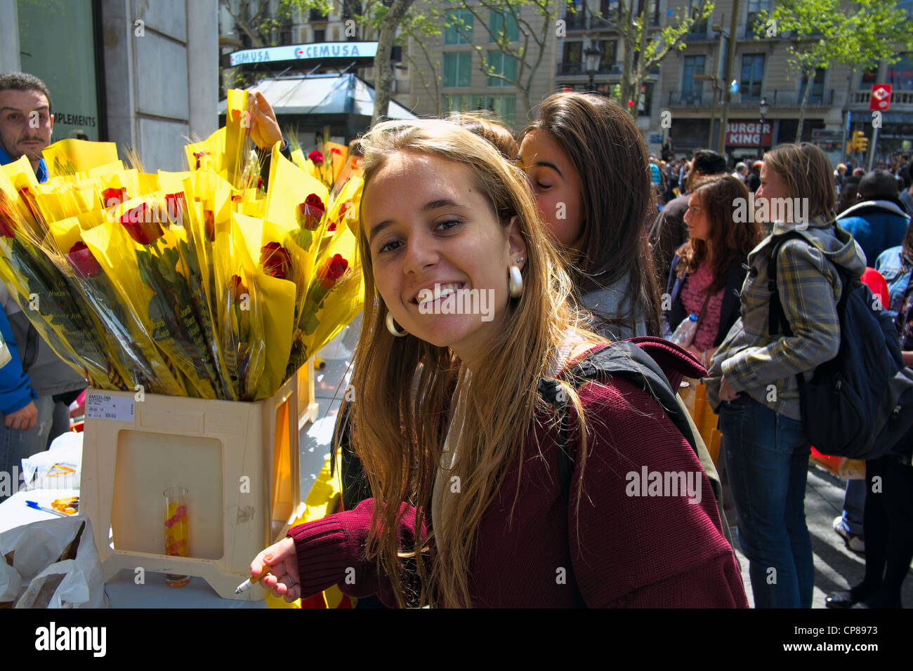 Young woman at rose vendor in Barcelona on St. George Day, 2012. Stock Photo