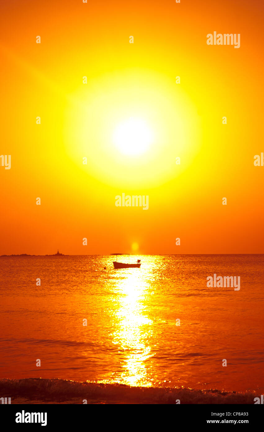 a boat on the sea at sunset in thailand Stock Photo - Alamy