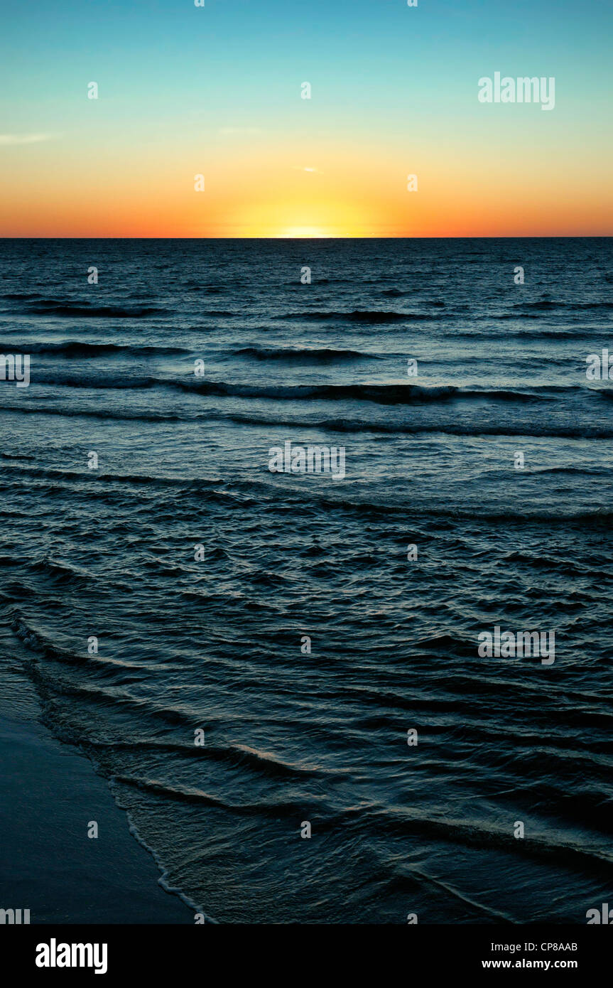 sun is setting over the sea at semaphore south australia Stock Photo