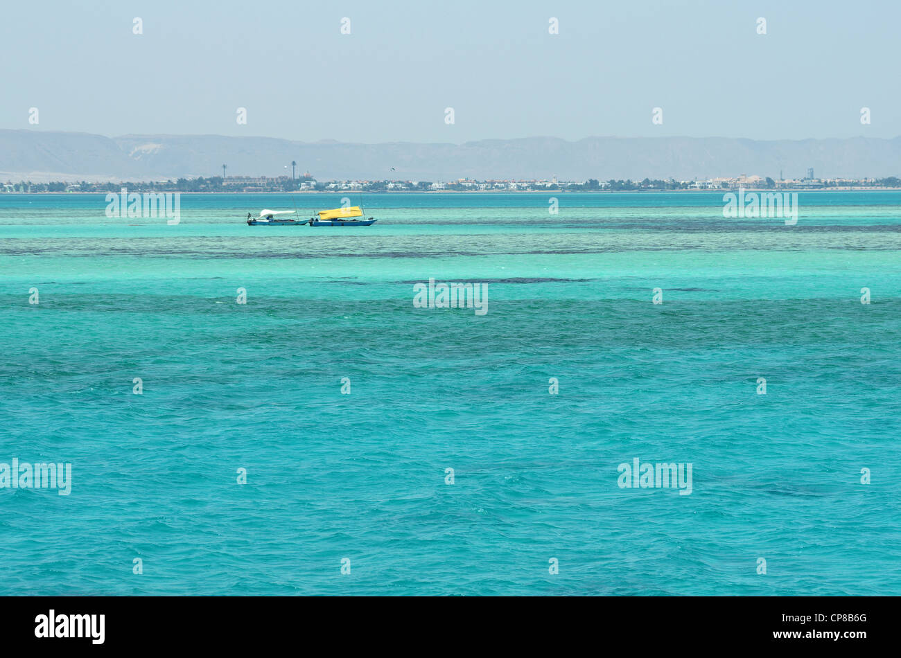 Blue clear water of Red Sea in Egypt , coast remote. Boats and coral reef Stock Photo