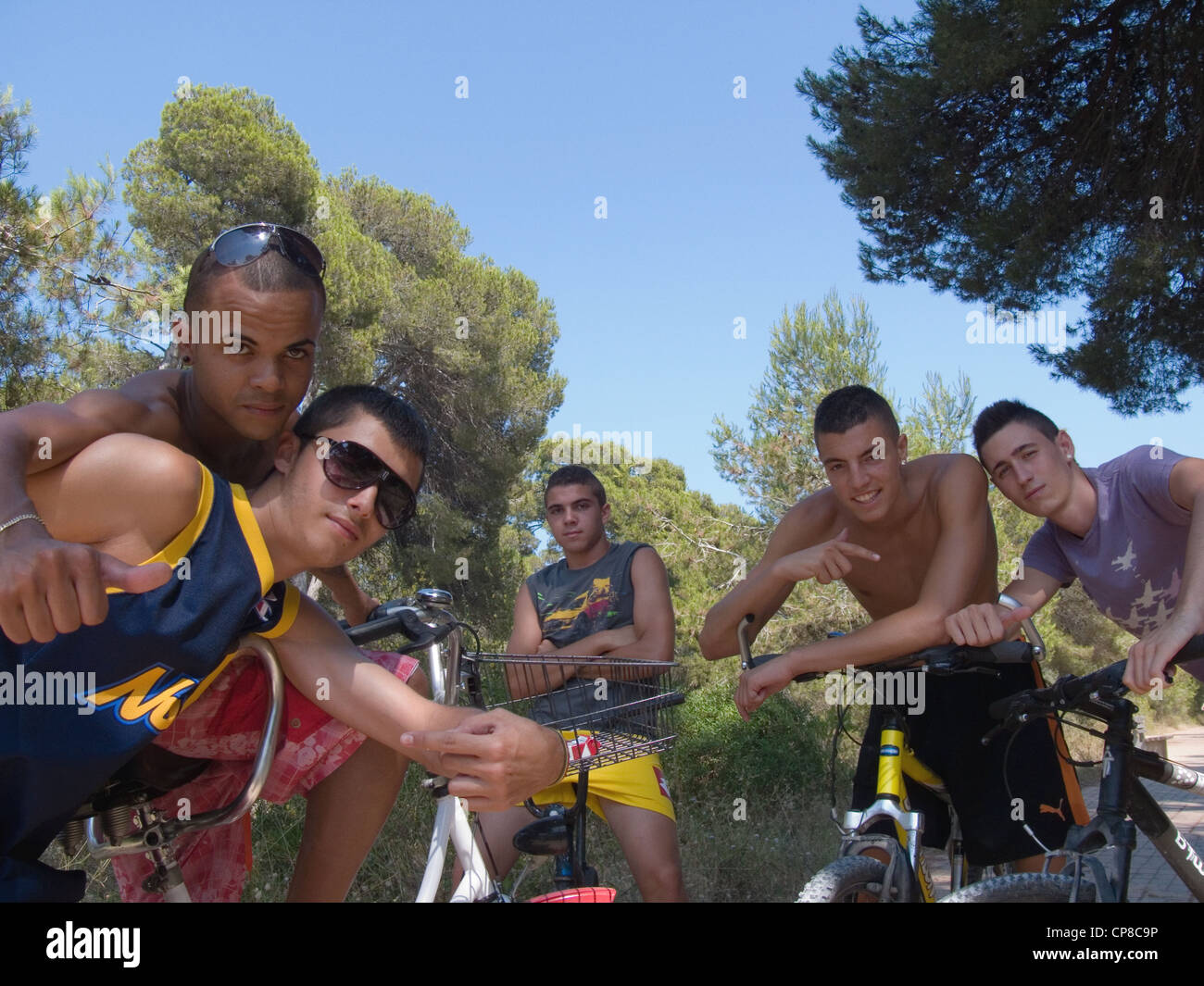 Guys cycling through the forest and dunes of El Saler, Valencia Stock Photo
