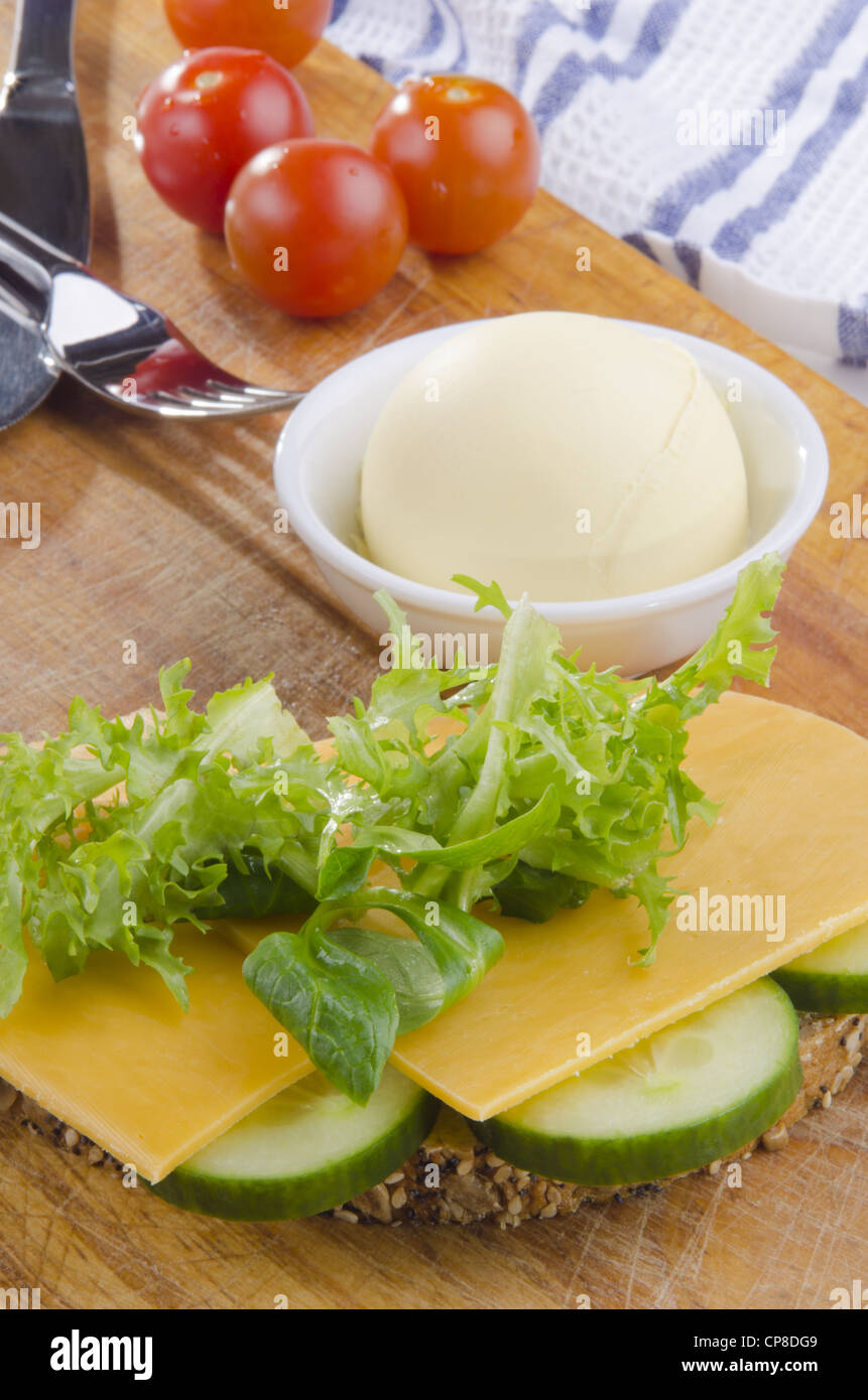 slice multigrain bread with mature cheese and sliced cucumber Stock Photo
