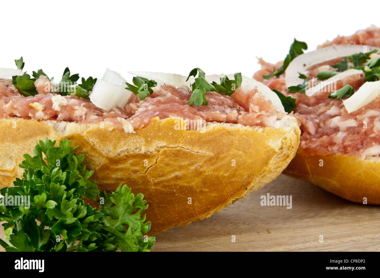 Rolls with minced pork (In German called Mettbrötchen) isolated on white background. Detailed closeup photo Stock Photo