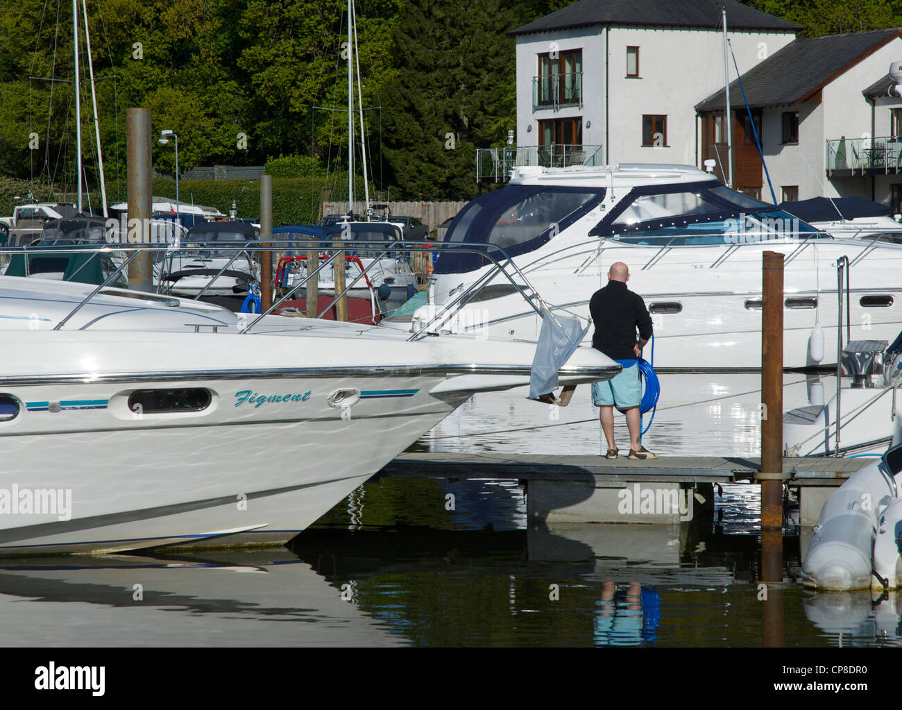 Man cleaning his boat in the Windermere Marina, near Bowness, Lake