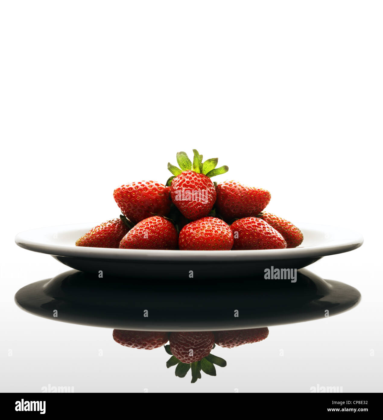 Red Strawberries on a Plate with Reflection Stock Photo