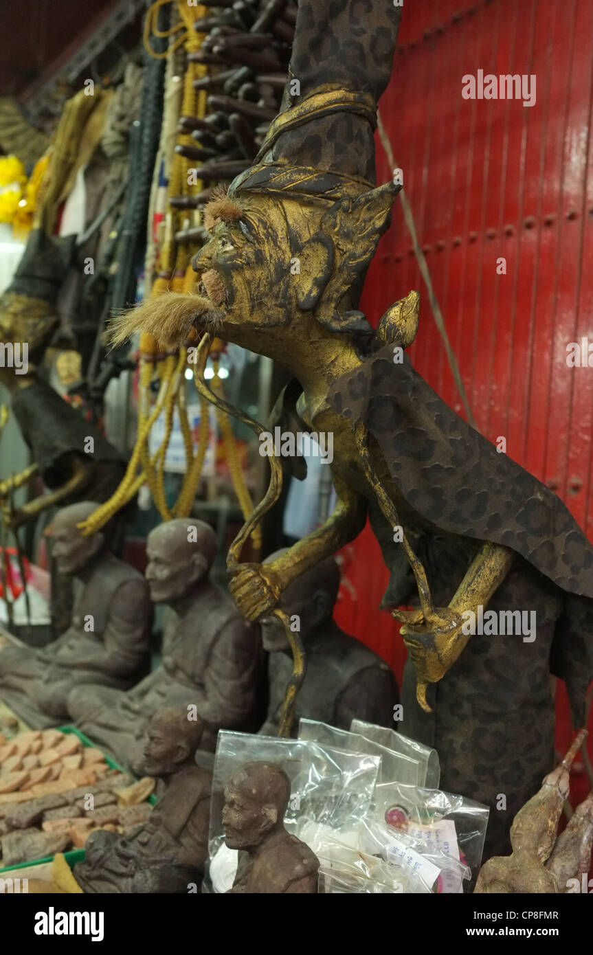 A selection of Thai protective religious amulets and Buddhist imagery on sale at a market in Bangkok near Wat Mahathat temple. Stock Photo