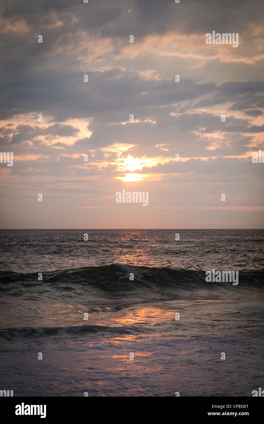 sunset over the sea sparkling water orange colours dramatic sky sun ...