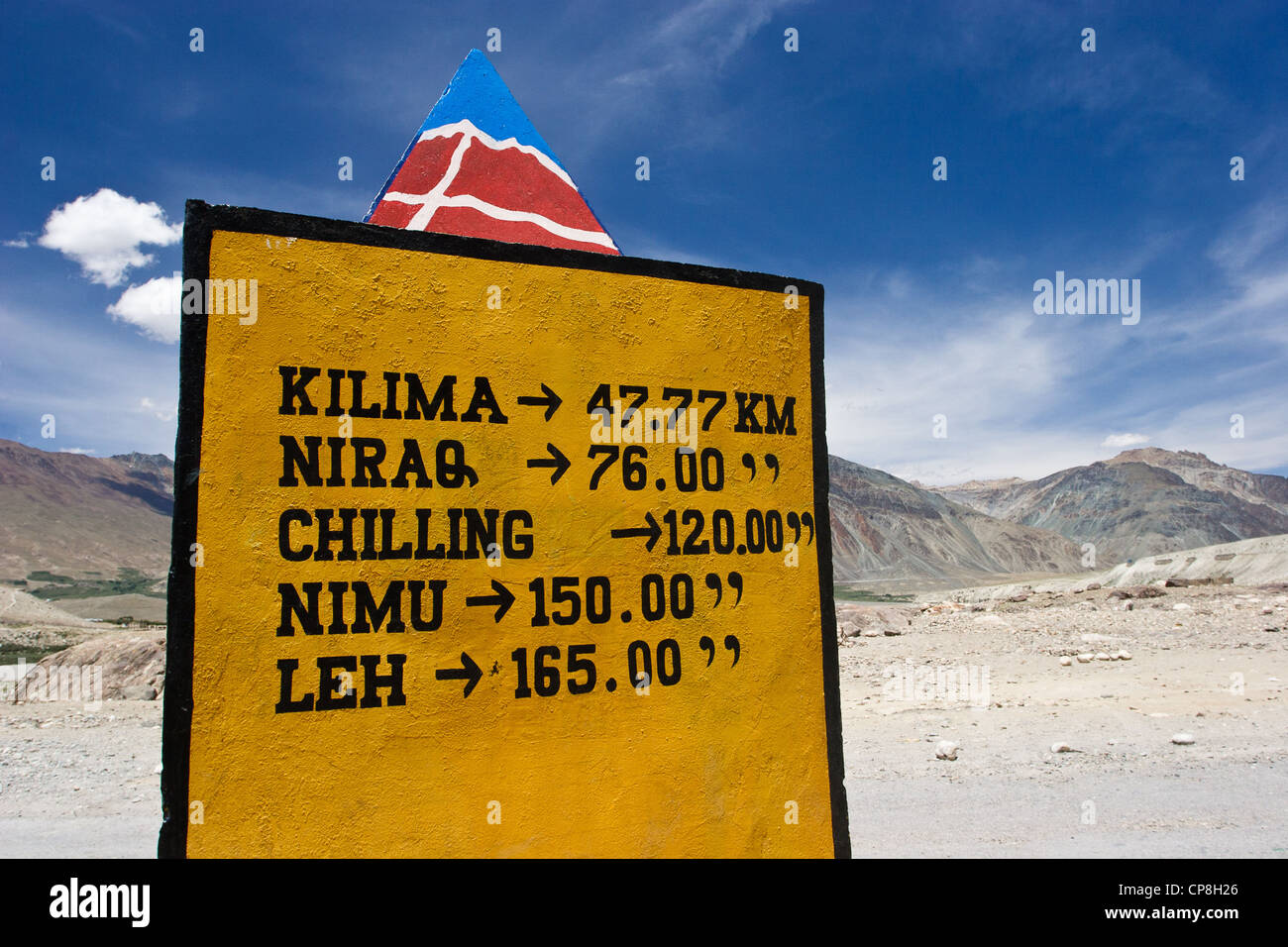 Traffic sign on the unfinished road in Zanskar (India, state of Jammu and Kashmir) indicates distances to villages and towns Stock Photo