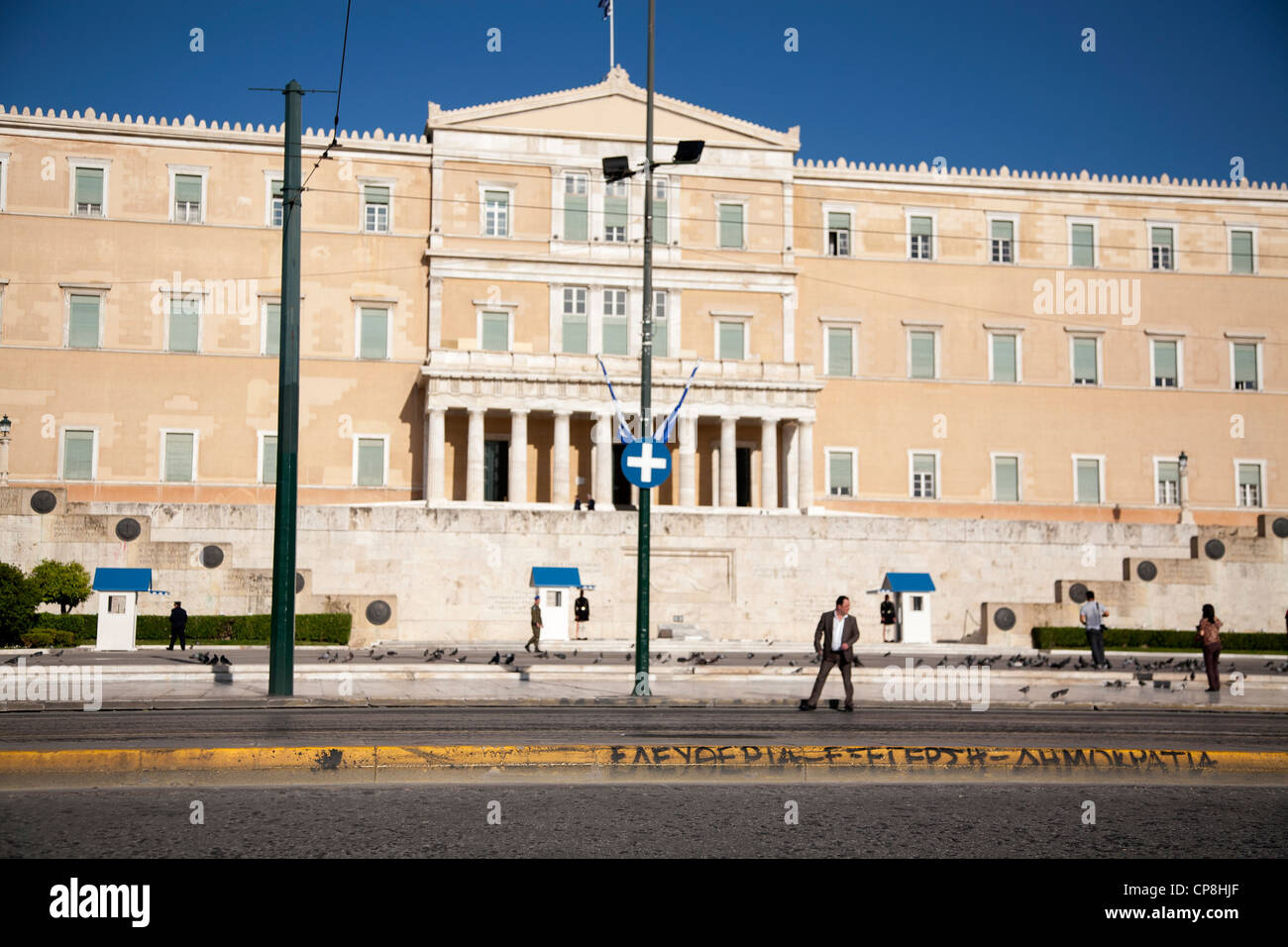 The Greek Parliament. A graffiti in pavement that reads freedom-uprise-democracy. Syntagma Square, Athens, Attica, Greece. Stock Photo