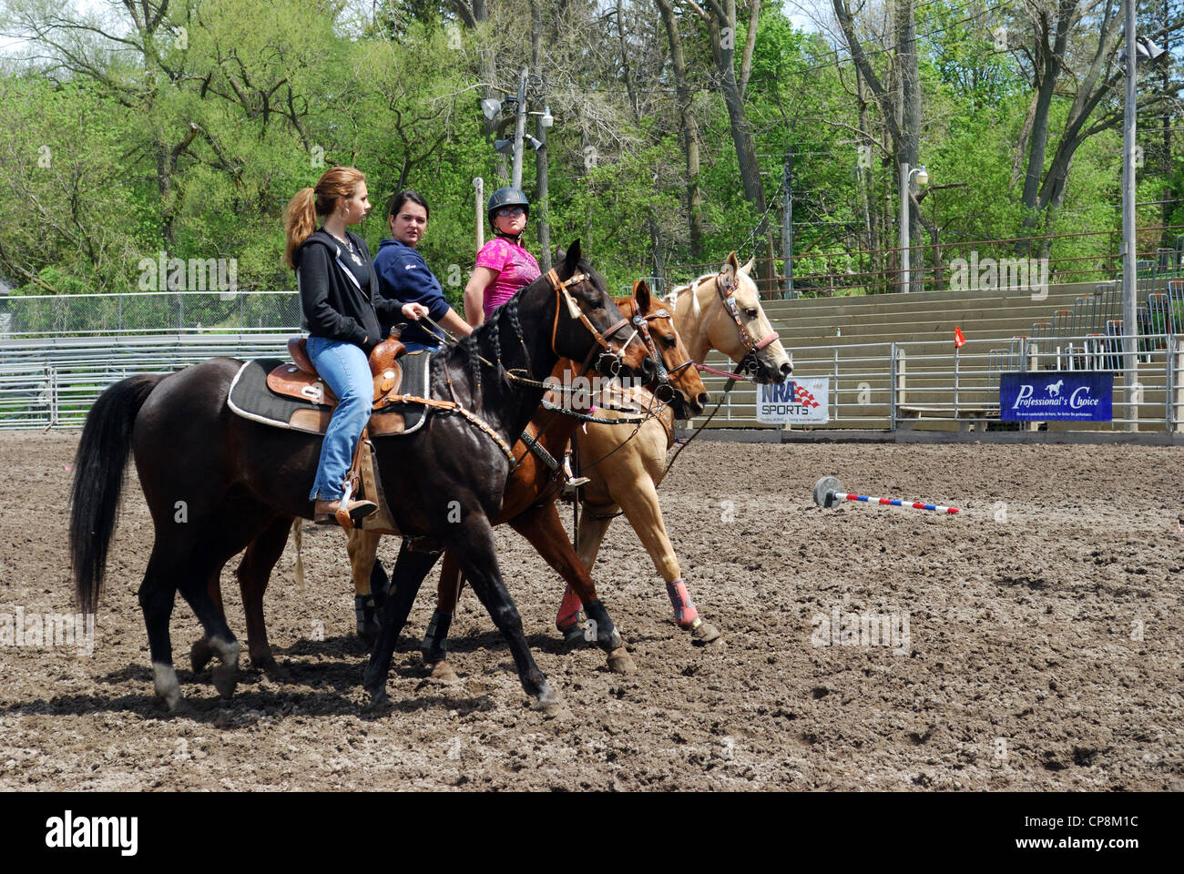 Teenage High schools girls cool off their horses at Attica Rodeo. Stock Photo