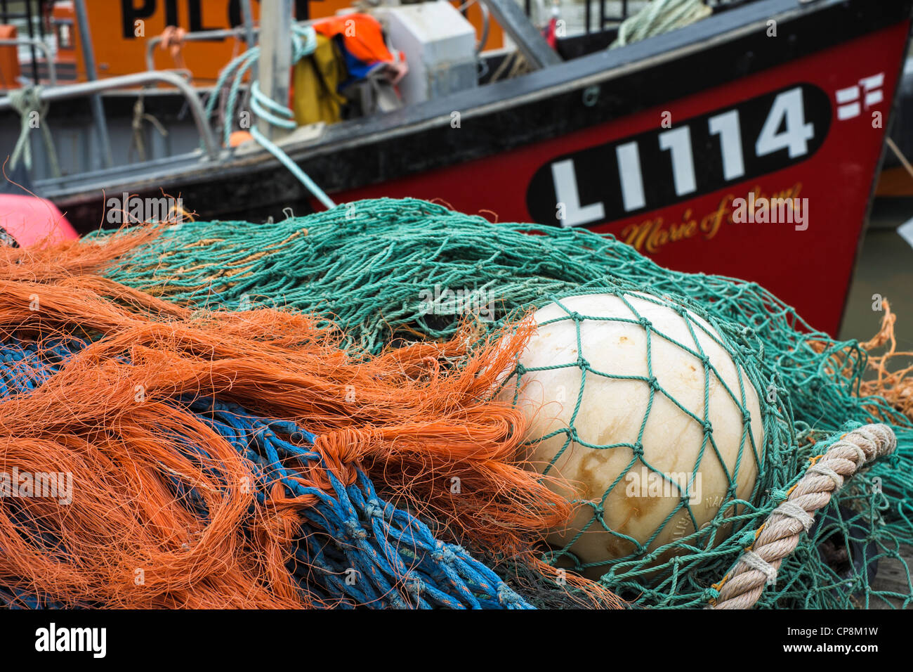 Fishing boat with nets and buoy hi-res stock photography and