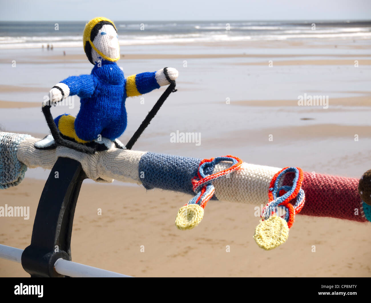 Yarn Bombing decorating public places with knitted objects here Olympic an Olympic skier on the Saltburn pier handrail Stock Photo