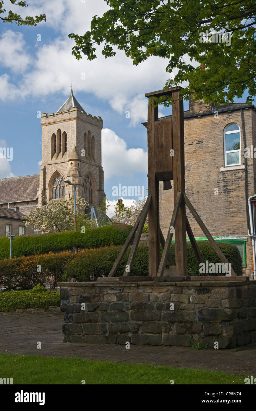 Replica of the Halifax Gibbet, with St Mary's RC church in background Stock Photo