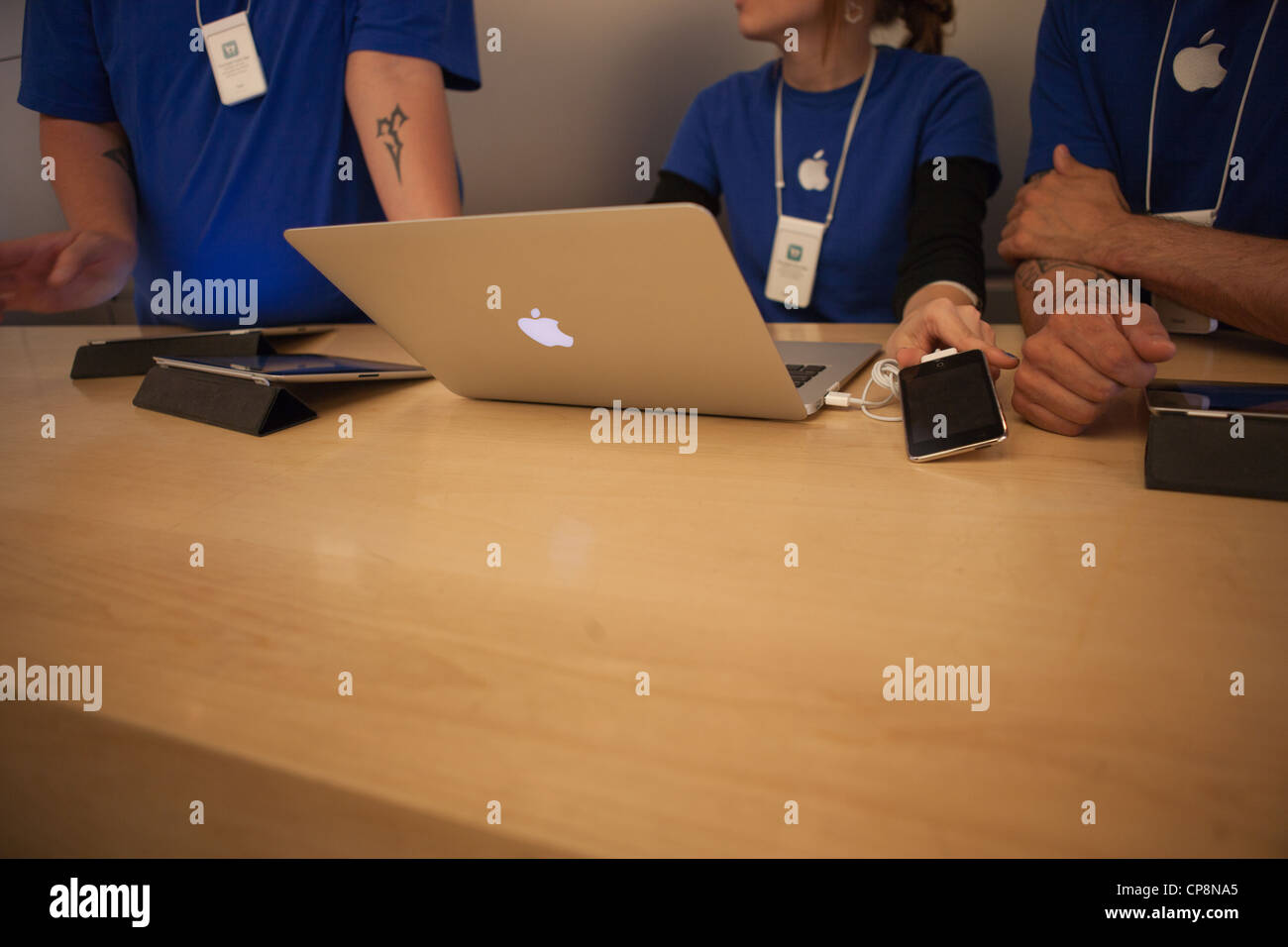 A Genius Bar Reservations Sign at an Apple Store in Front of the Genius Bar  Where Apple Employees are Helping Customers Editorial Stock Image - Image  of global, iphone: 237668444