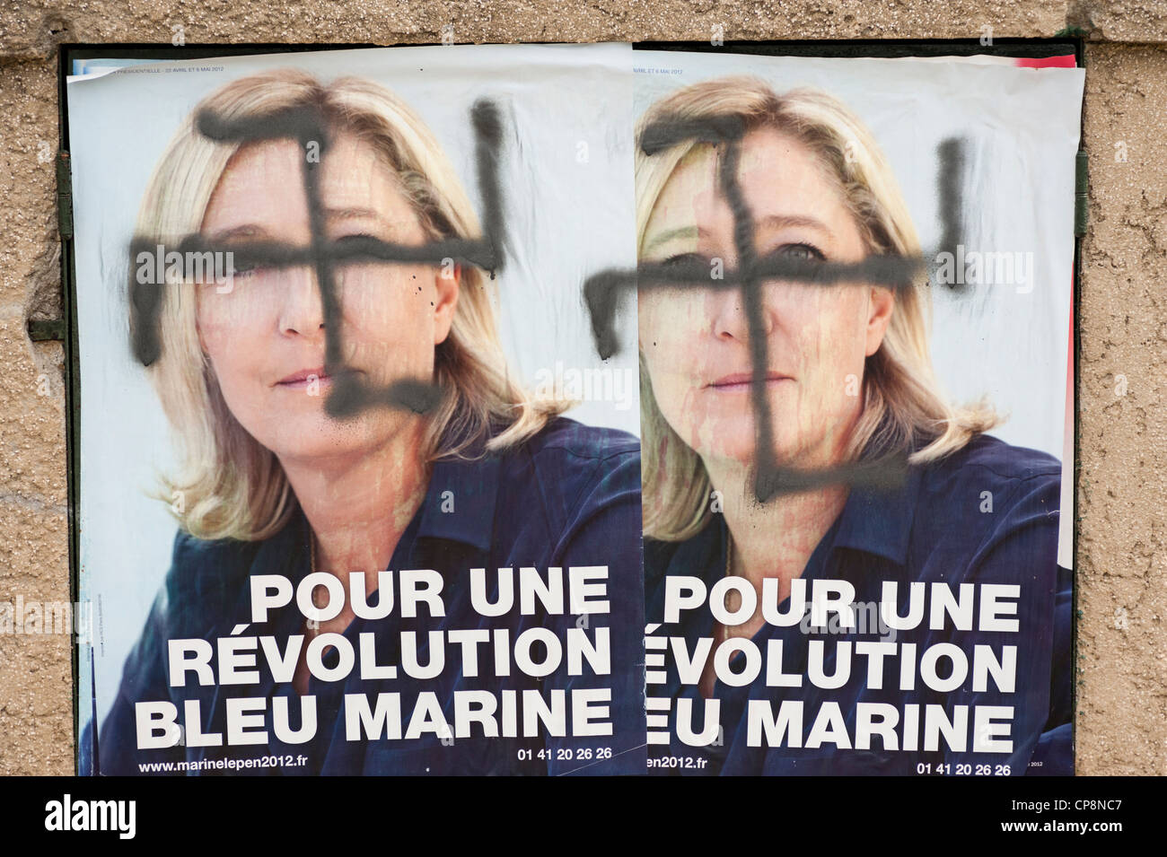 Swastika painted over posters of Marine Le Pen, France's far-right National Front political party leader - French elections 2012 Stock Photo