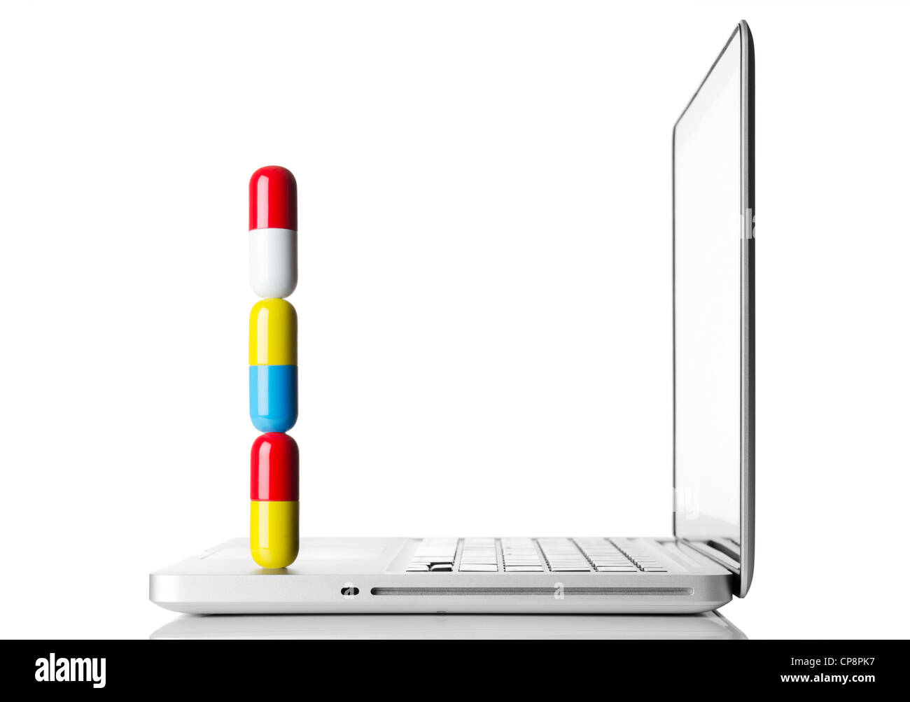 Large pills on a laptop computer Stock Photo
