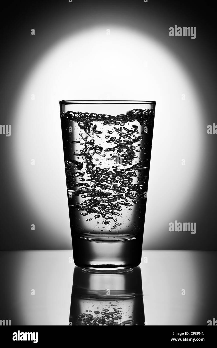 Glass of water on reflective surface Stock Photo Alamy