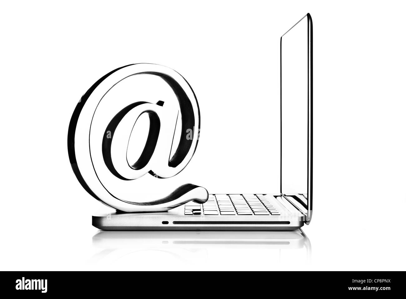 At symbol paper weight with laptop computer Stock Photo