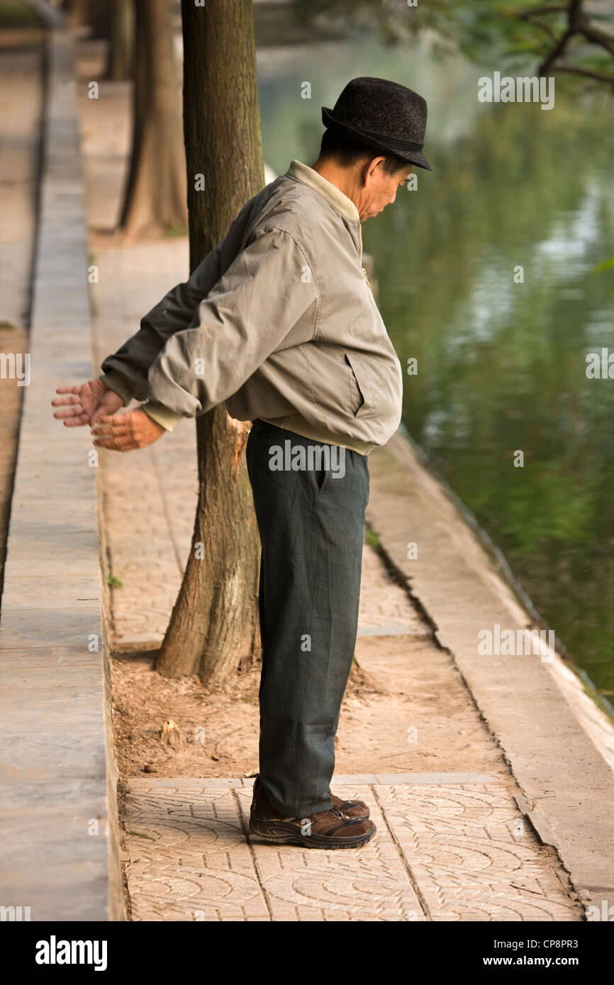 Man exercising on banks of Hoan Kiem Lake Stock Photo