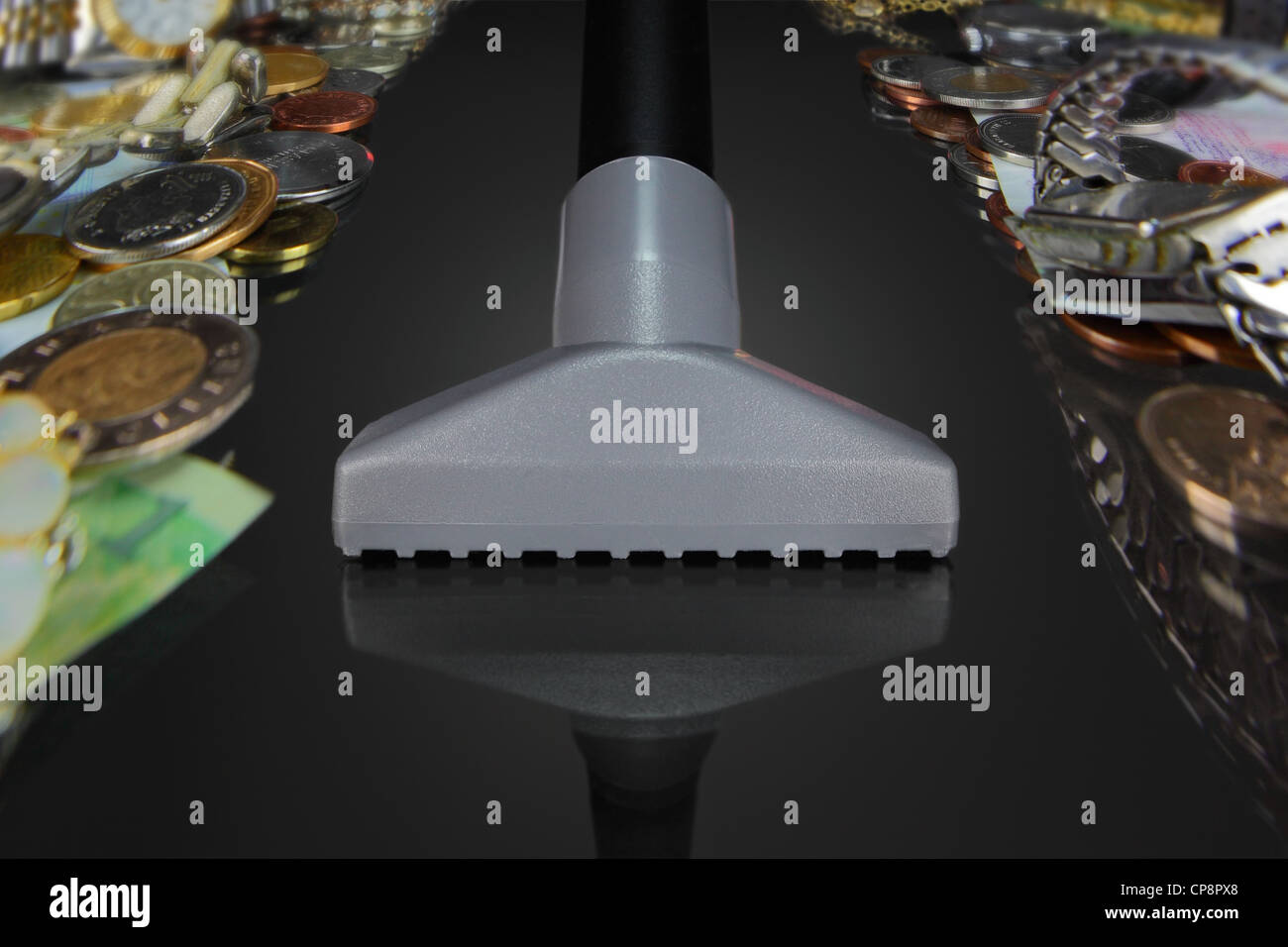 the brush of the vacuum picks up money and wealth, while leaving an