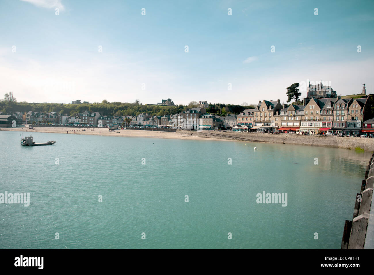 The waterfront of oyster capital Cancale with beach and restaurant row seen from the fishing pier, Brittany, France Stock Photo