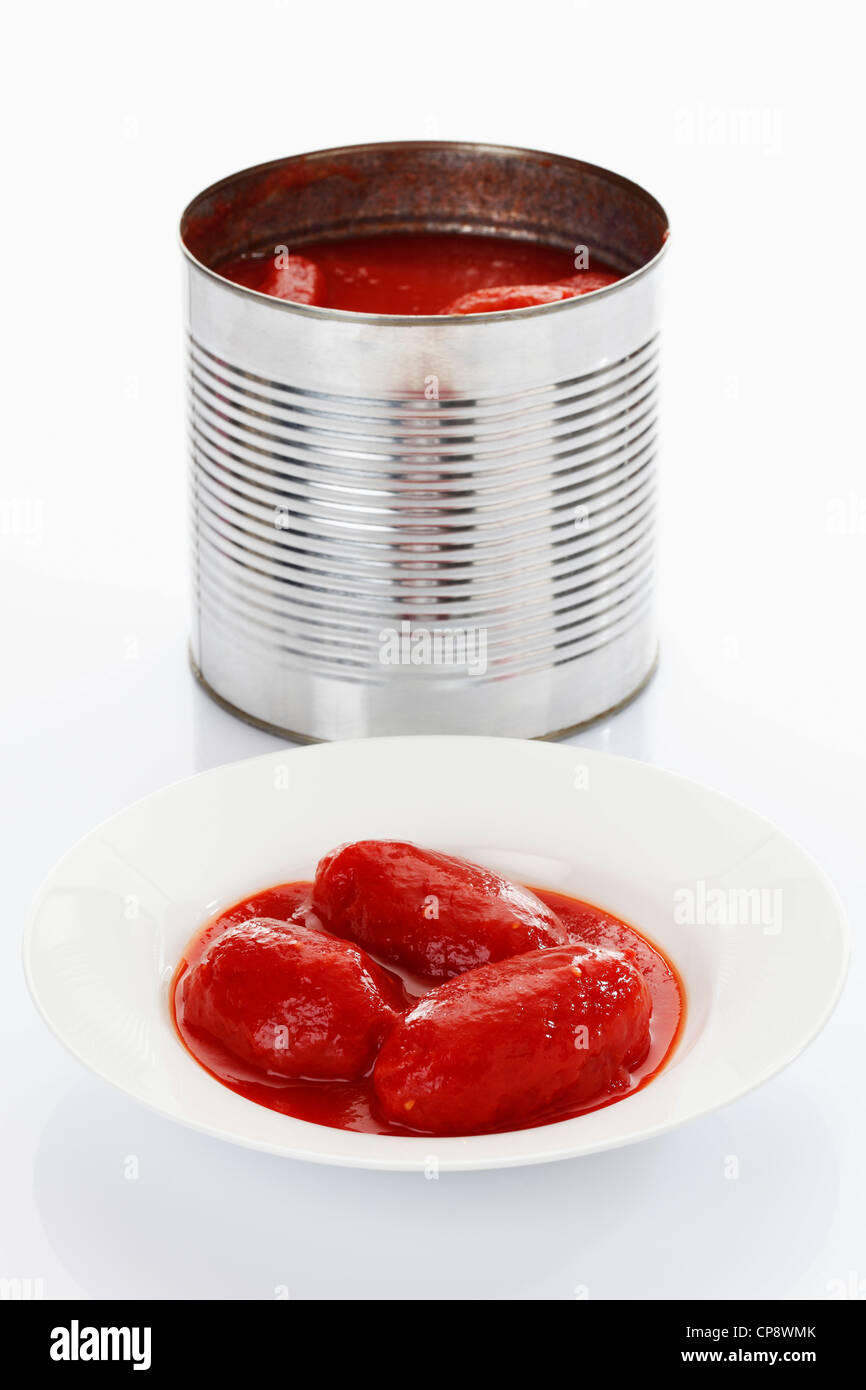 Peeled tomato in tin can and plate on white background Stock Photo Alamy
