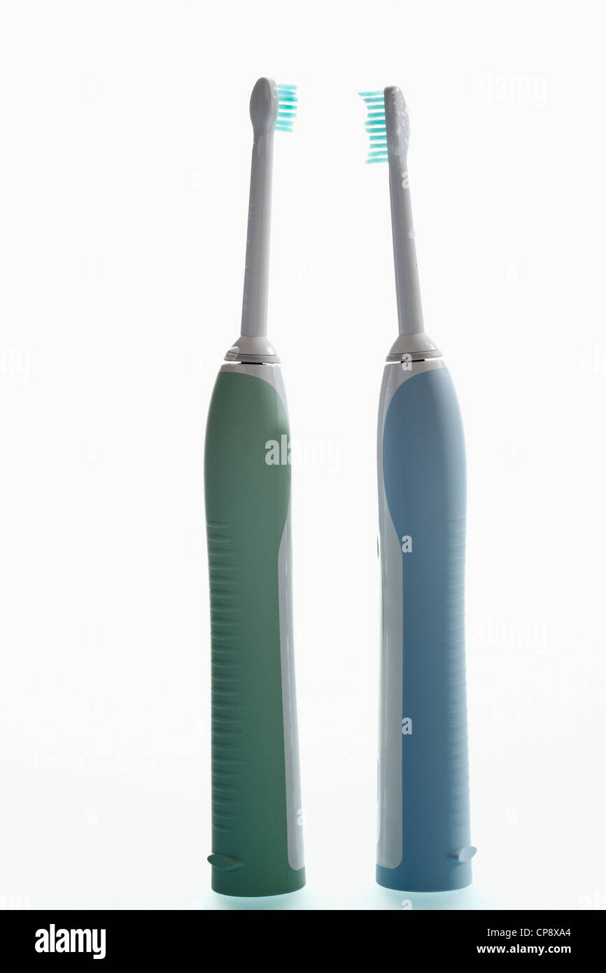 Electric toothbrushes on white background Stock Photo - Alamy