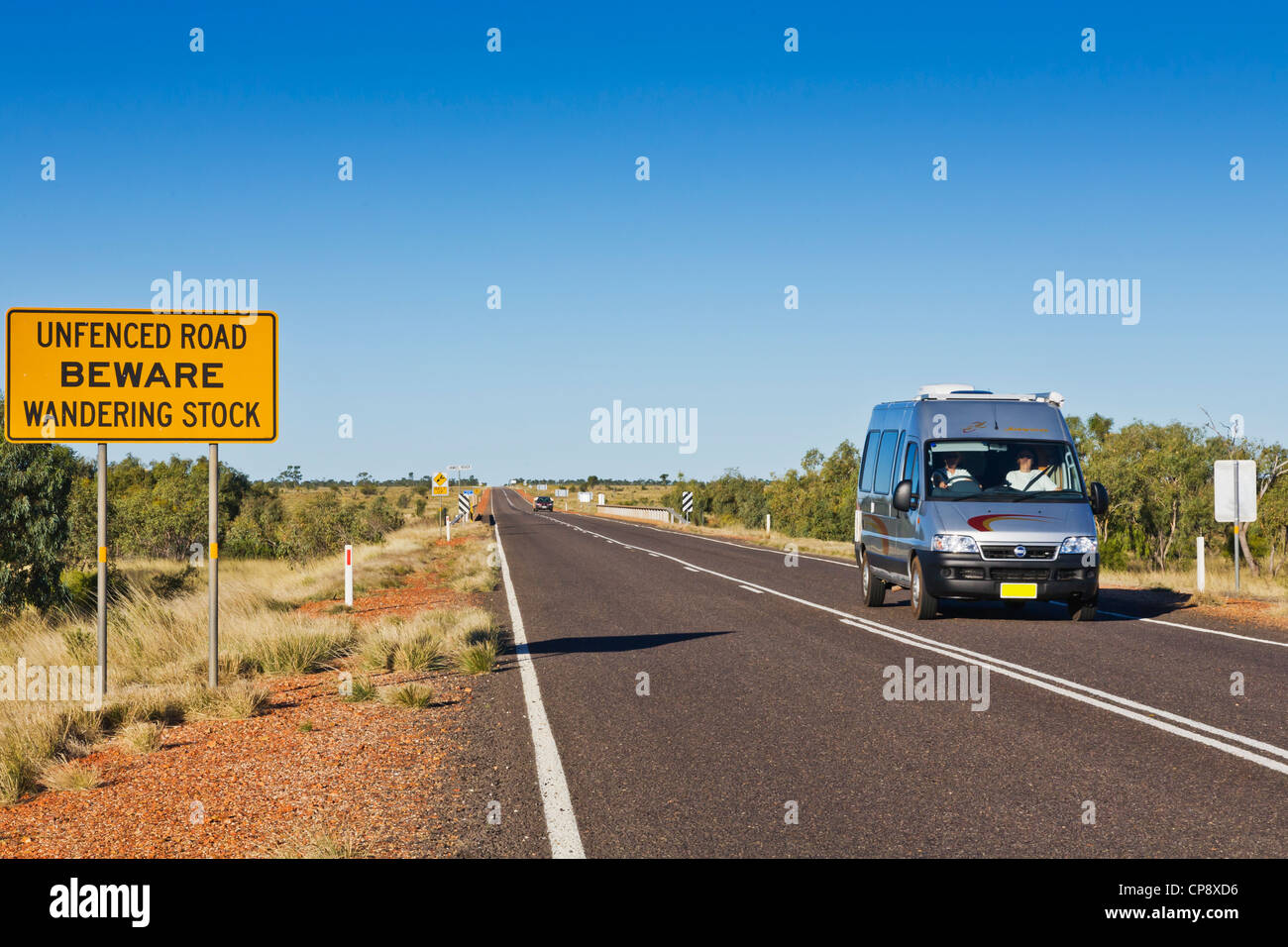 Campervan on the Barkly Highway in Outback Northern Territory, passing warning sign. Stock Photo