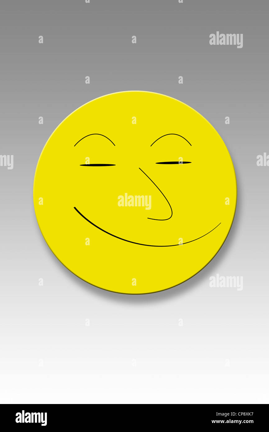 Yellow button with smiley face against grey background Stock Photo