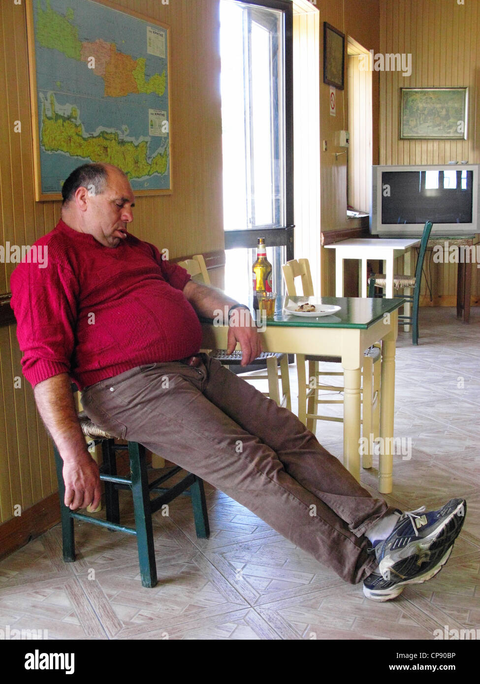 Man sleeping. Galatas Village Kafeneio, Crete, Greece Stock Photo