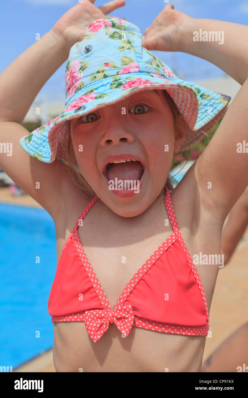 swim suit wearing a floral sun hat 