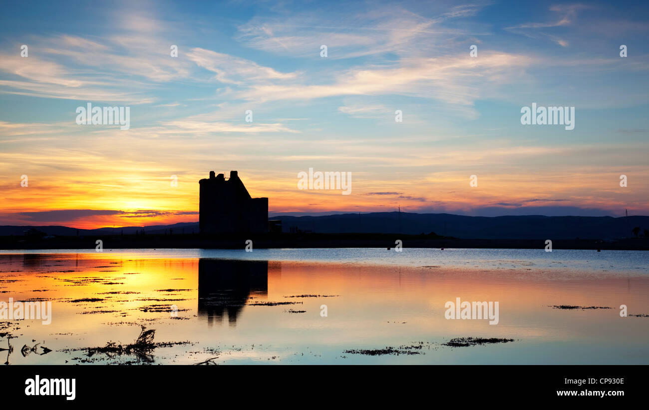 Lochranza Castle silhouetted at sunset, Isle of Arran, Ayrshire, England, UK Stock Photo