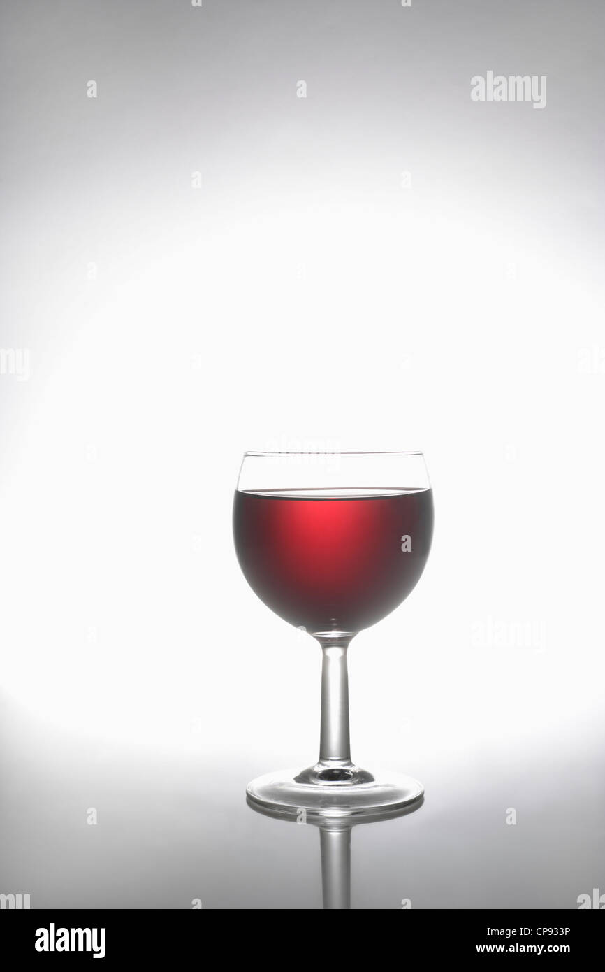 Glass of red wine on grey background Stock Photo