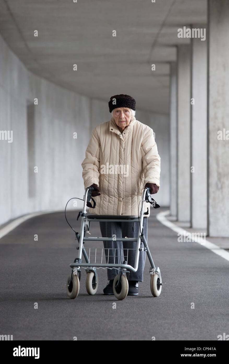 Austria, Senior woman with wheeled walker at Subway Stock Photo