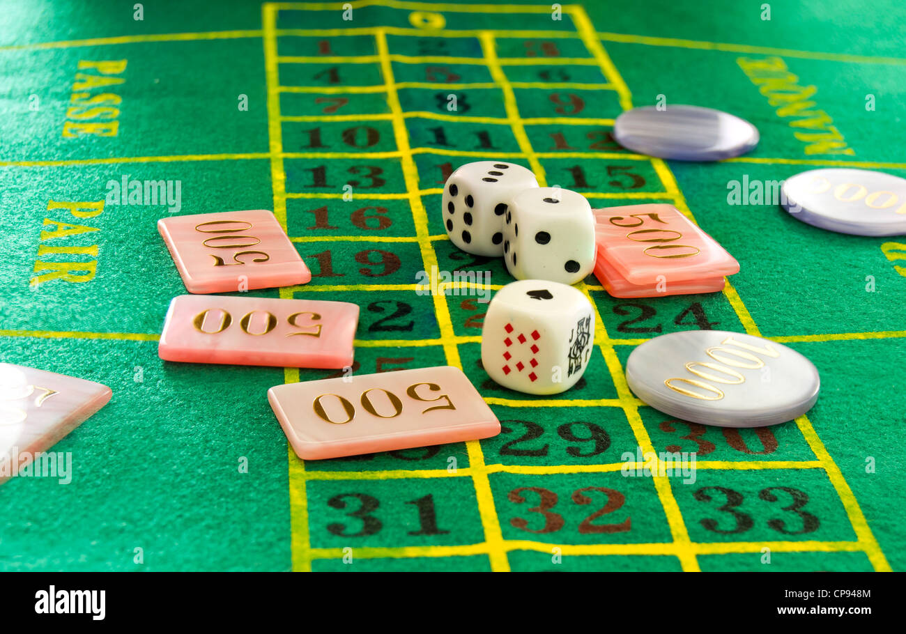 green table with dice and chips Stock Photo - Alamy