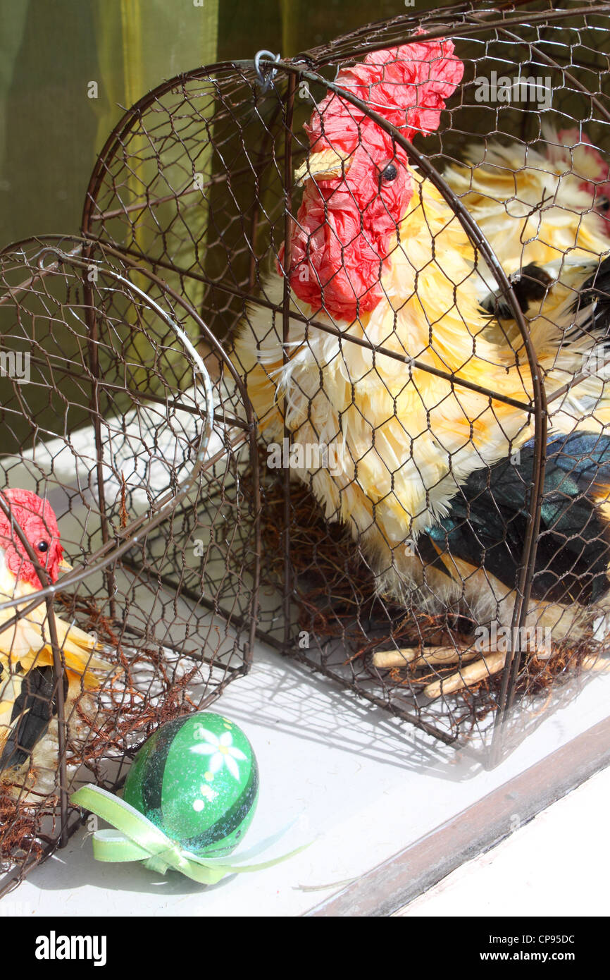 Easter toy chicken, chick, eggs in cage Stock Photo