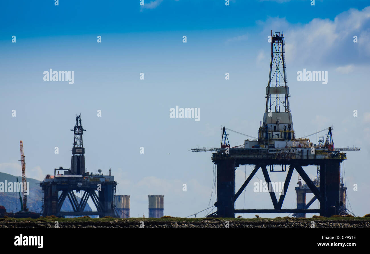 Oil rigs at the iFab Fabrication facility at Invergordon on the Cromarty Firth dwarf houses in the village Stock Photo