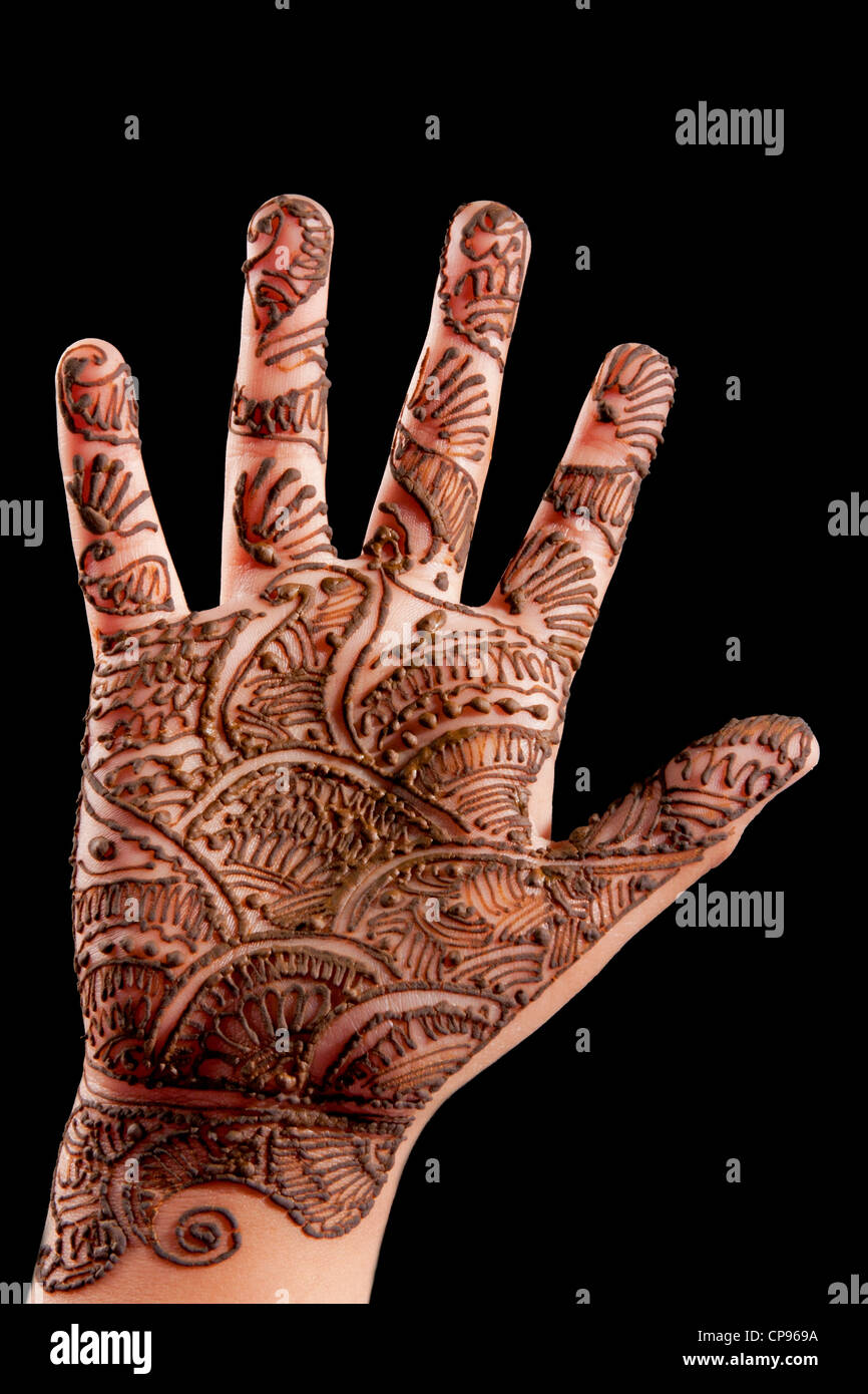 Henna (Mehendi) on a little girl's hand isolated on black Stock Photo