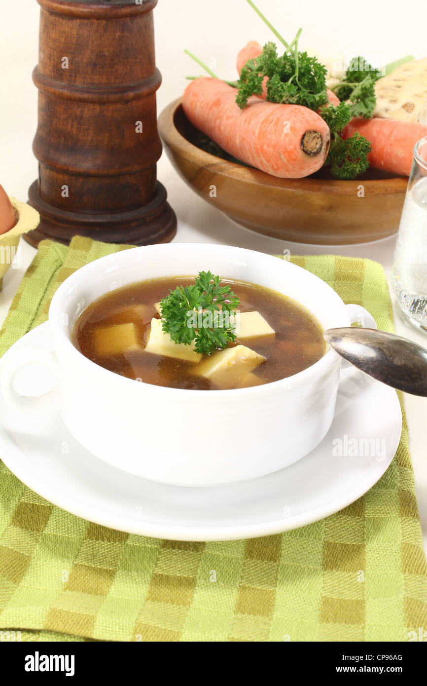 Beef consomme with soup vegetables, egg and parsley Stock Photo Alamy