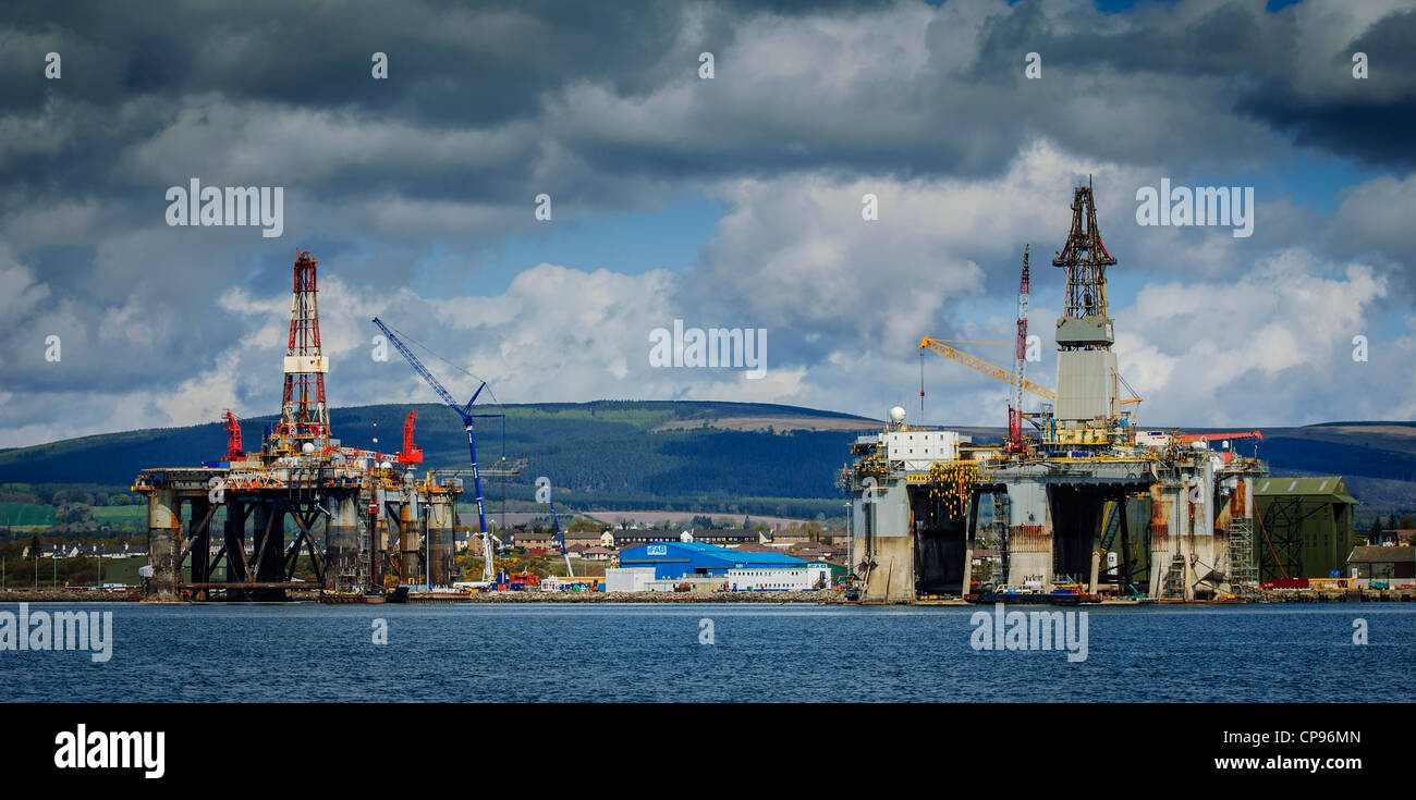 Oil rigs at the iFab Fabrication facility at Invergordon on the Cromarty Firth dwarf houses in the village Stock Photo